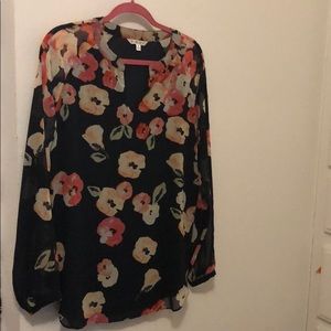 Floral printed blouse with sheer sleeve detail.